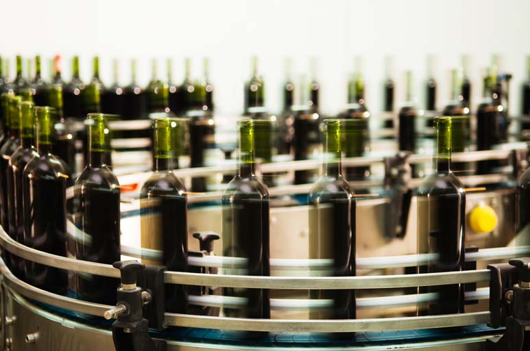 Photo of a wine bottling conveyor machine