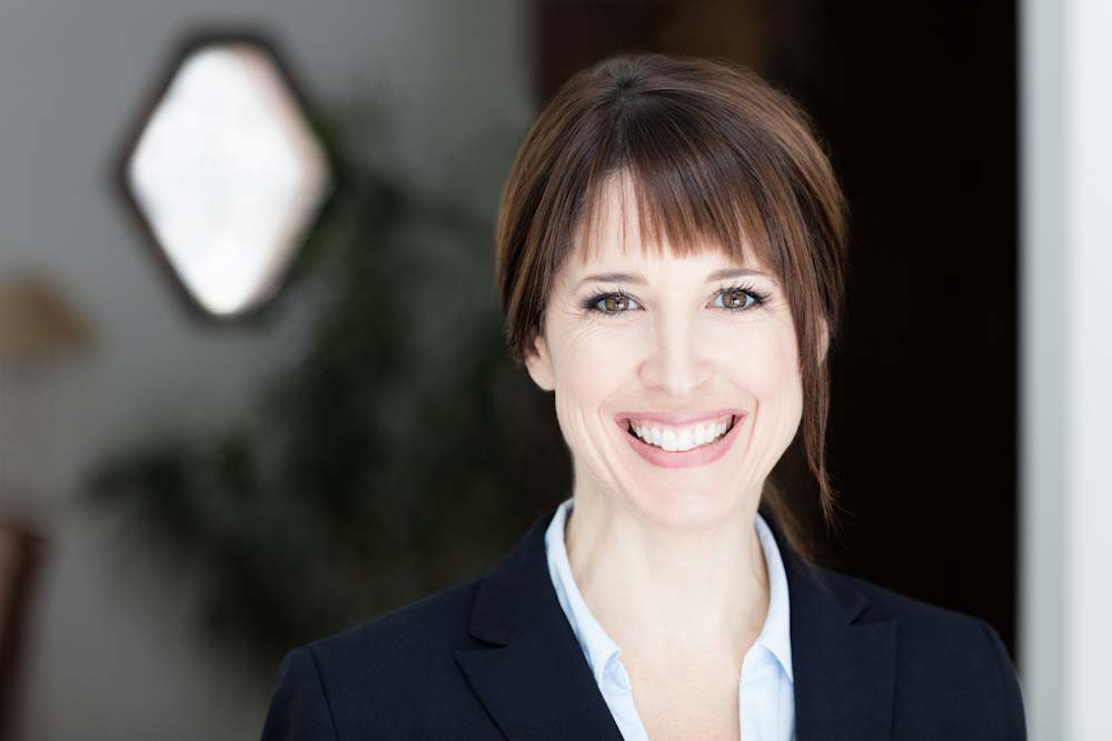 A photo of a woman in a business suit smiling