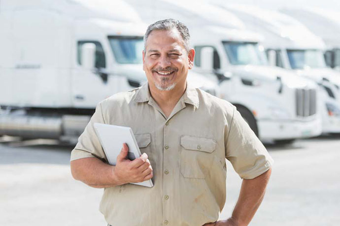 Photo of satisfied newly-hired truck driver employee about to start work