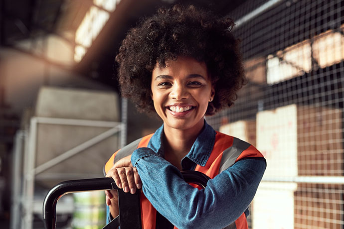 Photo of satisfied newly-hired warehouse employee about to start work