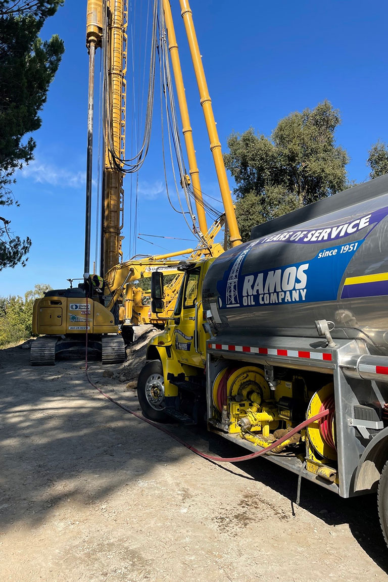 Ramos oil truck refueling an excavator