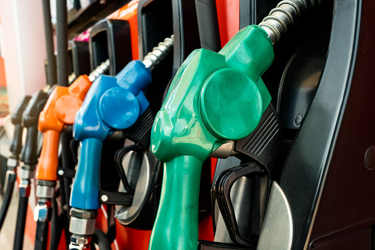 Petrol pump filling fuel nozzle in gas station. Ramos Oil Cardlock Fuel Stations offer cleaner fuels for our customers, like renewable diesel and other green energy options.