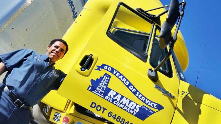 Photo of a Ramos Oil driver standing next to his Ramos Oil Fuel Delivery Truck