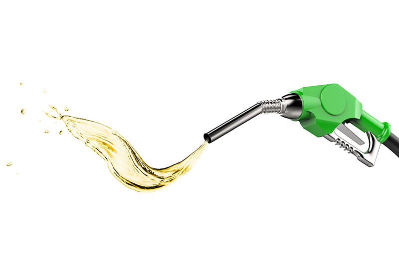A photo showing a green gas pump spraying renewable diesel fuel.