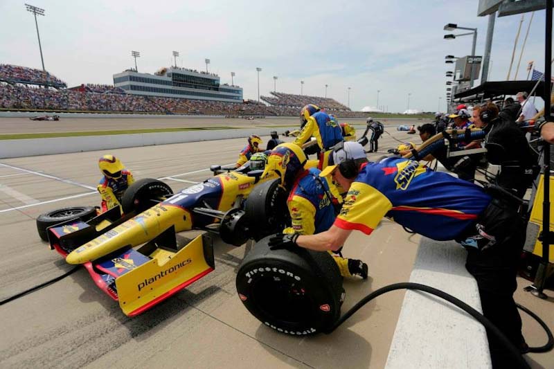 Photo of the Sunoco Race Fuel Race Team working on their Indy Car during a pit stop